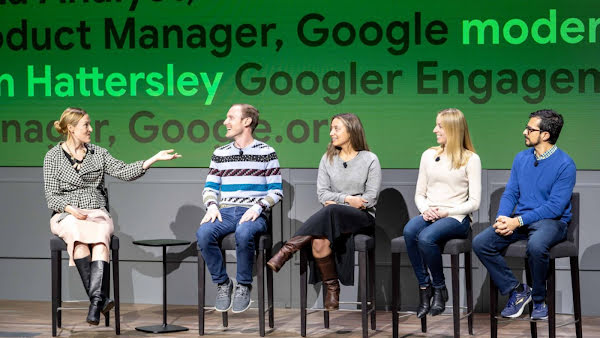 Erin sitting on the far left of a panel, pre-COVID, hosting a panel discussion with AI Impact Challenge grantees who received support from Googlers to advance their projects