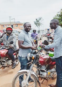 Two men working on a motorcycle.