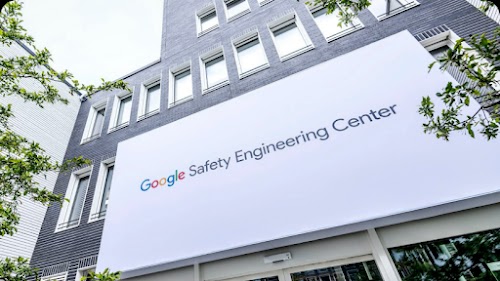 A Google Safety Engineering Center billboard outside a skyscraper.