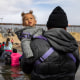 A migrant crosses the Rio Grande with his child attempting to reach the United States border in Ciudad Juarez, Mexico