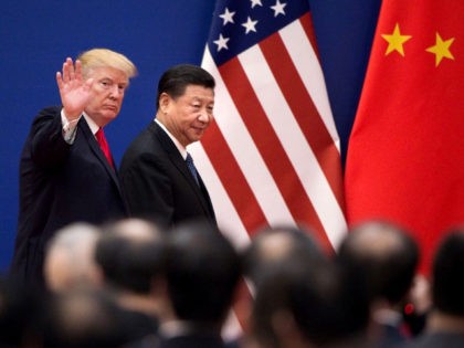 US President Donald Trump (L) and China's President Xi Jinping leave a business leaders ev