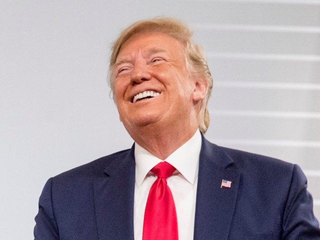 U.S. President Donald Trump and German Chancellor Angela Merkel laugh during a bilateral m