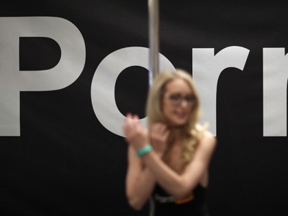 Porn actress Ginger Banks stands in the Pornhub booth during the AVN Adult Entertainment E