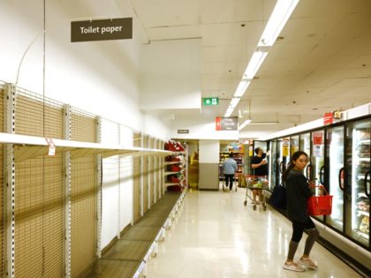 Shelves are empty of toilet rolls in a supermarket in Sydney on March 4, 2020. - Australia