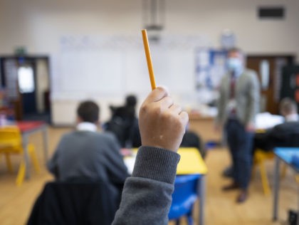 CARDIFF, WALES - SEPTEMBER 14: A pupil raises their hand during a lesson at Whitchurch Hig