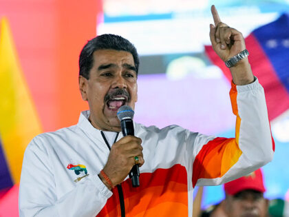 President Nicolas Maduro speaks to pro-government supporters after a referendum regarding