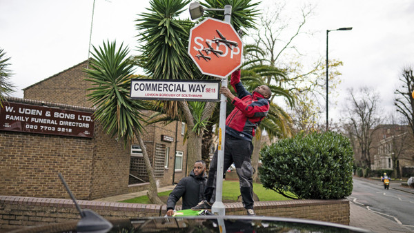 Am Freitag: Zwei Unbekannte montieren das mutmaßliche Kunstwerk von Banksy in London ab.
