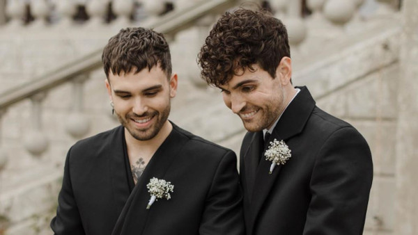 Duncan Laurence (rechts) und sein Mann schneiden die Hochzeitstorte an.