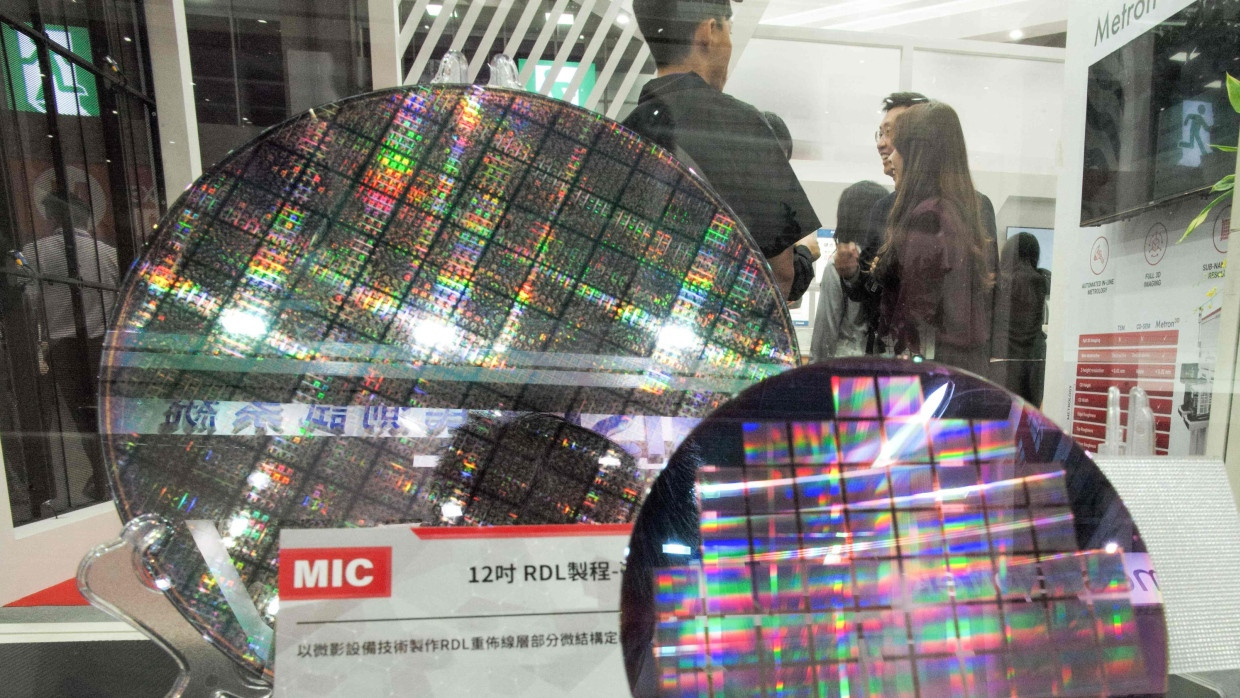 Wertvolle Technik: Besucher der Chipmesse Semicon in Taipeh stehen hinter sogenannten Chip-Wafern.