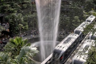 Skytrain shuttles passengers between terminals through the Jewel complex at Changi Airport, Sunday, July 16, 2023, in Singapore.