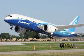 Brand new Boeing 787 Dreamliner in factory paint scheme taking off during EAA Airventure 2011