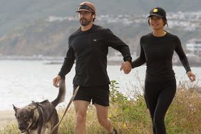 04/25/2024 EXCLUSIVE: Milo Ventimiglia and wife Jarah Mariano hold hands on a jog in Los Angeles. The couple then sat on the tailgate of their truck as they took in the ocean view with their dog.
